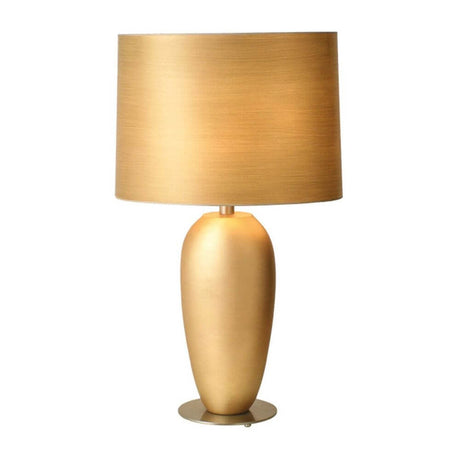 Bordlampe Omega Oval Grande keramikk-metall bladforgylt med gyllen overflate og elegant lampeskjerm.