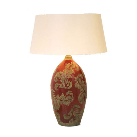Lampe de table Toulouse en céramique émaillée rouge-boue avec design élégant et motif de feuilles.