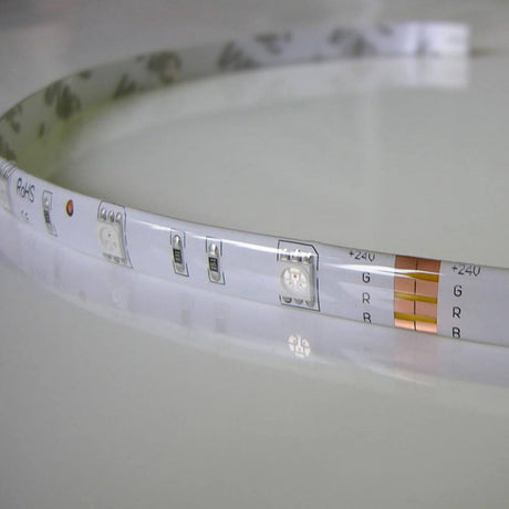 14, 4 W/m RGB IP65 24V 5m LED-Strip IP63 auf einem Tisch liegend, Detailansicht der LED-Beleuchtung.