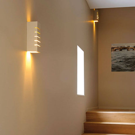 GL 100 Slot square wall light white plaster E14 max. 40W on a wall in a modern staircase.