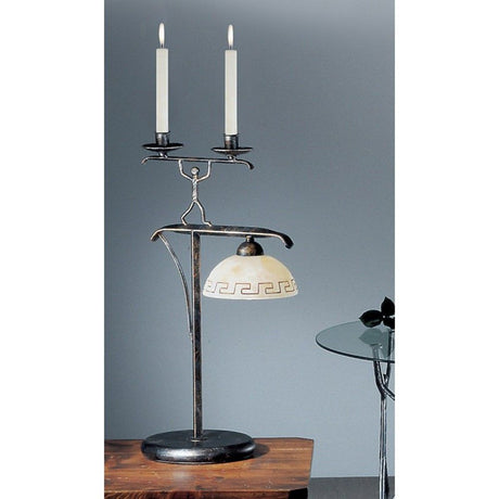 Lampa stołowa Ethno czarno-złoto-srebrna z 2 świecami stołowymi 59 cm na stole o nowoczesnym designie.