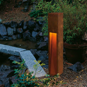 Rusty Slot 80 iron rusted E27 ESL max. 11W IP44 in a garden, emits warm light.