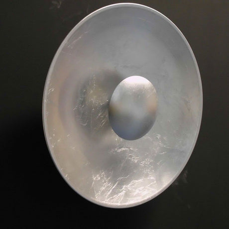 Aura Sol silver wall and ceiling light, silver leaf foil, Ø 40 cm on a black background.