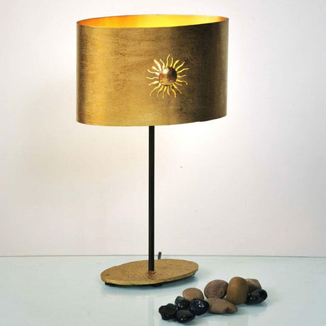 Lampada da tavolo Sun Oval in ferro oro-marrone-nero con simbolo solare e base in pietra.