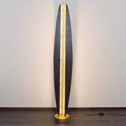 Floor lamp Simbolo iron brown-black-gold in an elegant design with warm light on wooden floor