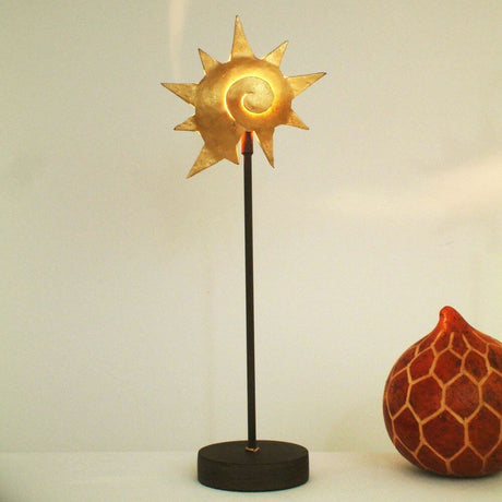 Table lamp Piccola Lumache iron brown-black-gold with golden sun symbol on a black base.
