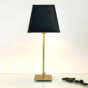 Table lamp Mattia Square Iron Gold-Black with black shade and gold frame on smooth table.