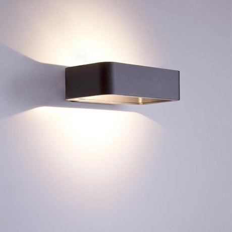 Uno LED utendørs vegglampe 13 cm Up&Down antrasitt på en vegg, minimalistisk og moderne.