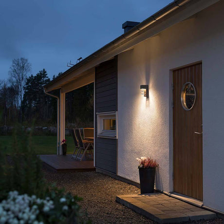 Acerra LED anthracite outdoor wall light on a modern house at dusk.