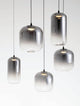 Aelia LED Pendelleuchte 9-flammig  Ø 82cm Schwarz, Rauch mit eleganten, rauchgrauen Glaslampenschirmen.