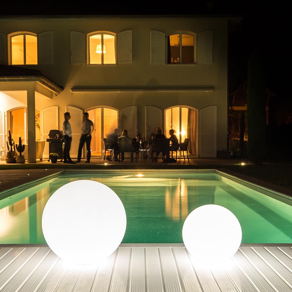 Akku LED-Lichtkugeln am Pool bei Nacht, modernes Design, atmosphärische Beleuchtung für entspannende Abende.