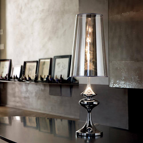 Alfiere table lamp with mirrored shade, chrome, on a table, elegant design with metal and PVC.