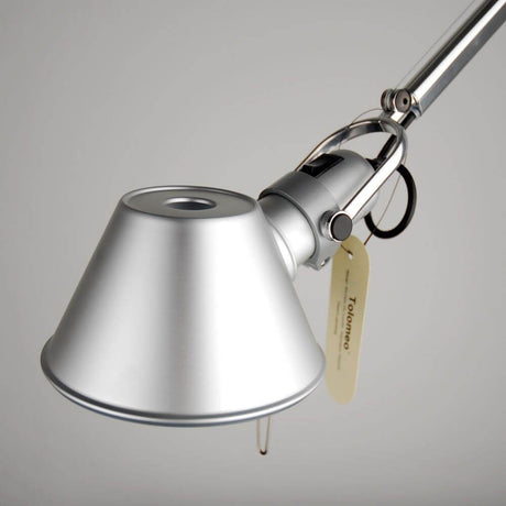 Close-up of the Artemide Tolomeo Lettura floor lamp with a silver lampshade and a flexibly adjustable arm.