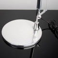 Detailaufnahme des Fußes der Artemide Tolomeo Micro Tischlampe mit glänzender Oberfläche und schwarz-weißem Hintergrund.