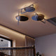 s.luce Artus LED Deckenlampe mit einzigartigem Design und runden, flachen Lichtquellen in einem modernen Raum.