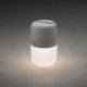 LED solar light Assisi for hanging or standing gray on a dark background, shining brightly.