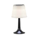 LED Tischlampe Assisi Schwarz auf einem Tisch, modernes Design ideal für Garten oder Terrasse.