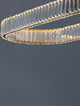 Aurelia LED Pendelleuchte 3500K mit filigranen Glasstäben und goldfarbenem Metallring.