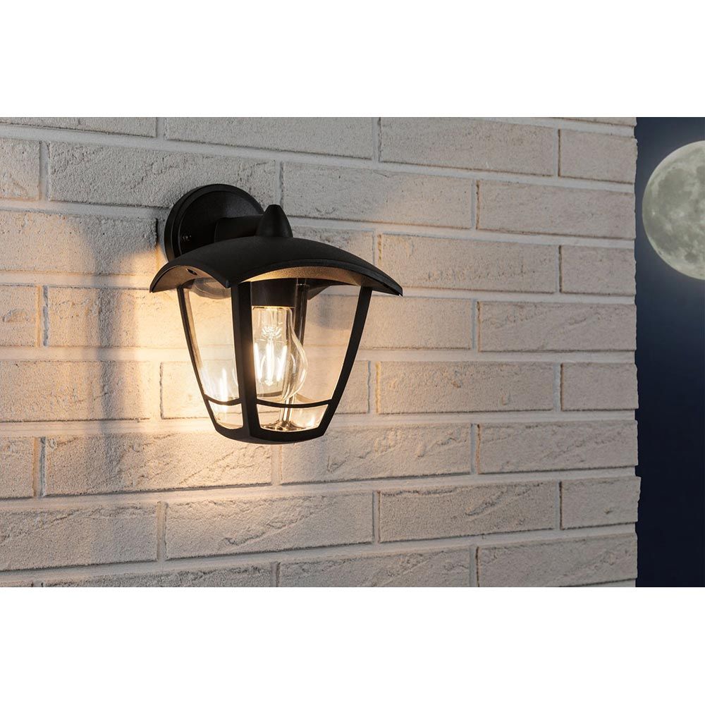 Außenwandleuchte Classic Curved in anthrazit an einer Wand mit klarem Glasschirm und Retro-Glühbirne.