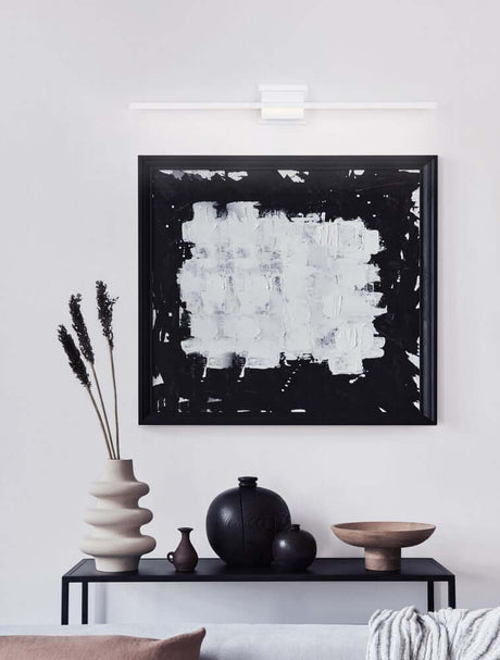 Azure LED wall light 3000K white above a modern artwork in a stylish living room.