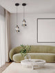 Bally LED Pendelleuchte Ø 20cm 2-flammig im Wohnzimmer mit grünem Sofa und minimalistischer Dekoration.