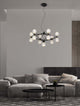 Belinda LED Pendelleuchte Ø 89cm 13-flammig in modernem Wohnzimmer über Couch und Tisch
