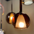 s.luce Belluna Pendelleuchte aus mundgeblasenem Cognac-Glas mit warmem Licht für stilvolle Innenräume.