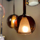 s.luce Belluna Pendelleuchte aus mundgeblasenem Cognac-Glas mit warmem Licht für stilvolle Innenräume.