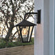 Benu outdoor wall lamp black, smoked acrylic glass mounted on the wall in the outdoor area.