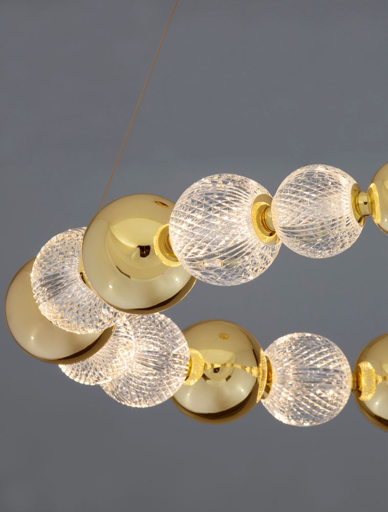 Brille LED Pendelleuchte mit goldenen Elementen und gläsernen, funkelnden Lampen.