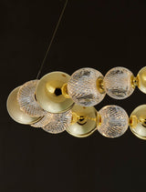 Brille LED Pendelleuchte in Gold mit Kristallkugeln, elegantes Design für stilvolle Beleuchtung.