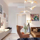 Brokis Hängeleuchte Night Birds mit normalem Flügel in modernem Wohnraum mit beiger Couch und Kunstwerken.