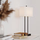 Bordlampe Luton hvit på et bord med bøker, stilrent og elegant design for ethvert oppholdsrom.