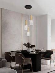 Certa 3-light pendant light Ø 30 cm Black, Gold above an elegant dining table in a modern setting.