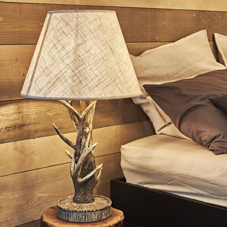 Chalet wood antler table lamp with metallic support structure and handcrafted resin decorations.