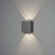 Chieri LED Wandleuchte Up & Downlights an einer Wand, strahlend in grauem Design.