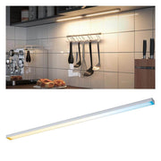 Clever LED kitchen light Barre 55cm White, matt chrome above a kitchen worktop with cooking utensils.