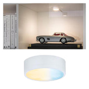 Clever LED Spot Medal White Matt, mounted in the cabinet and illuminating a model car.