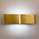 Clip Wandleuchte Up&Down 44cm Blattgold an der Wand, aus Metallfolie, elegantes Lichtdesign.