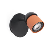 Coco spot wall light in modern design with orange finish and black holder, ideal for different rooms.