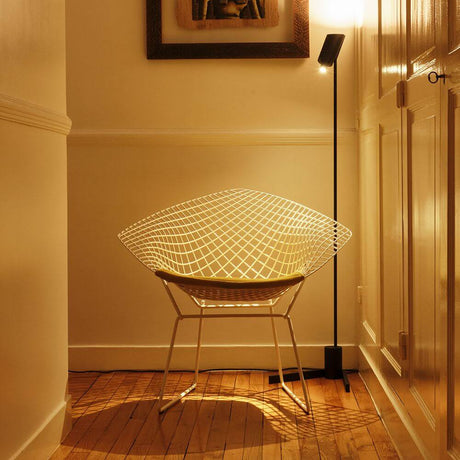 DCWéditions Vision 20/20 LED floor lamp 137cm next to a stylish chair in a cozy room.