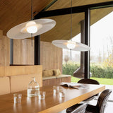 Moderne DCWéditions Mono Hängeleuchten im minimalistischen Wohnraum mit Holzdetails und Glasbehältern.