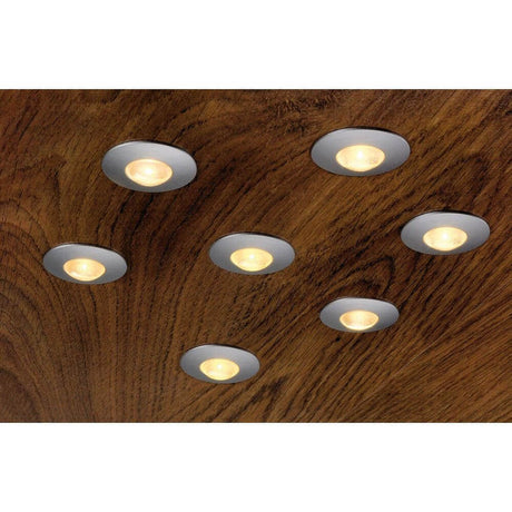 DEKLED round recessed light silver metallic 1W LED warm white 3000K installed in a wooden ceiling.
