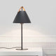 Tischlampe Strap Schwarz mit schwarzem Lampenschirm und Ledergriff auf einem Tisch.