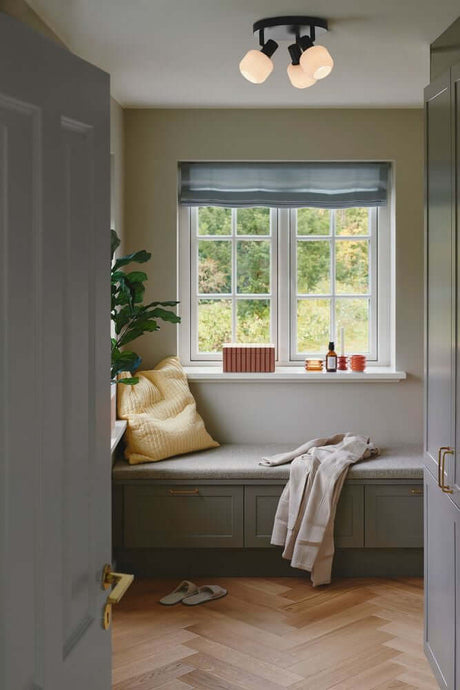 Plafonnier Milford Mini 3-Rondel au-dessus d’un coin fenêtre confortable dans un espace moderne.