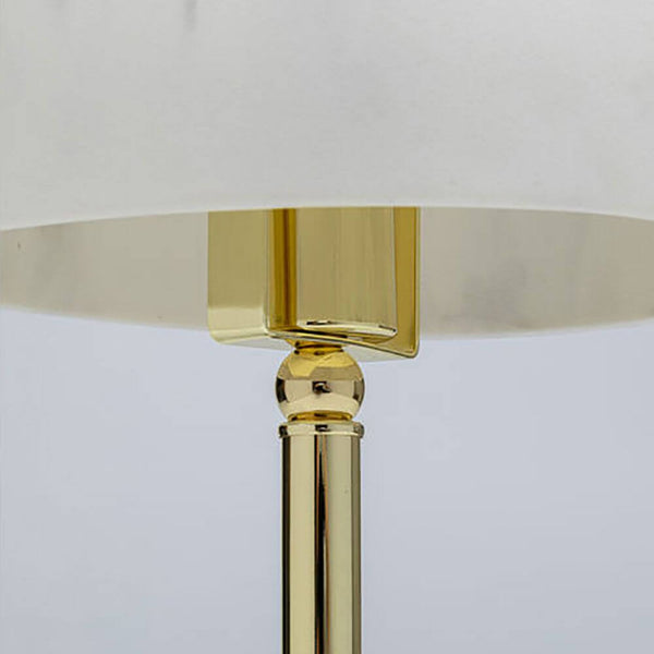 Close-up of the design table lamp Horn with a golden base and stylish lampshade.