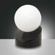 Gravity LED Tischleuchte aus Metall & Glas mit runder, mattweißer Glaskugel und schwarzem Sockel.