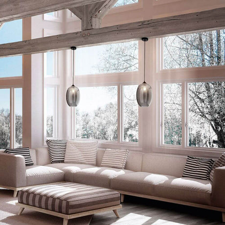 Infinity Pendelleuchte Rauchfarben im modernen Wohnzimmer über gemütlicher Couch.
