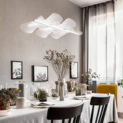 Sylvie LED pendant light clear wavy above an elegantly set table in a modern dining area.