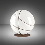 Fabbian Armilla table lamp, burnished, with glossy white glass and polished metal rings.